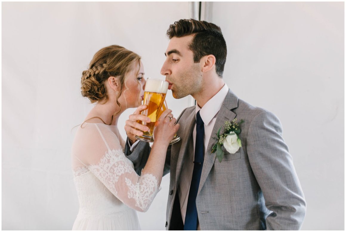 bride and groom drinking beer at wedding reception at graeme park