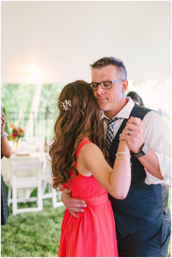 groom dancing with bride's daughter during reception at backyard wedding