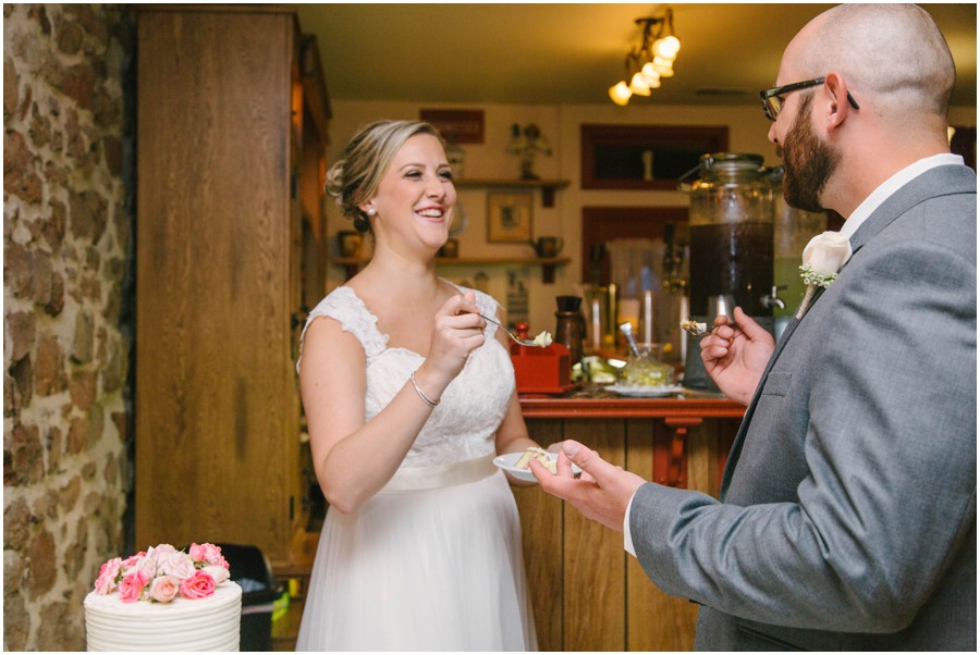 bride and groom feeding each other cake at meredith manor