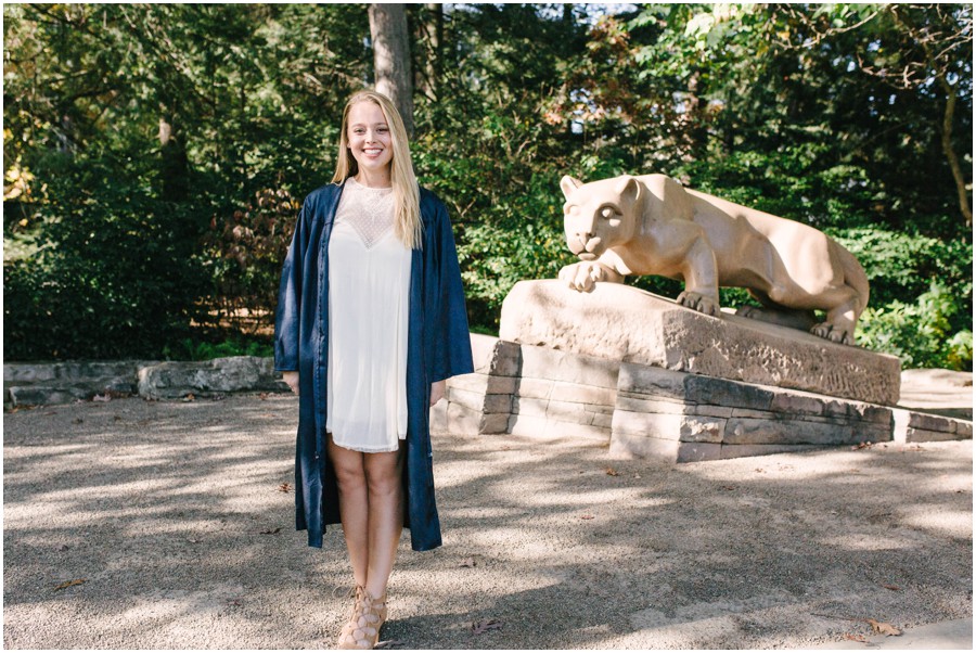 penn state graduate by nittany lion statue 