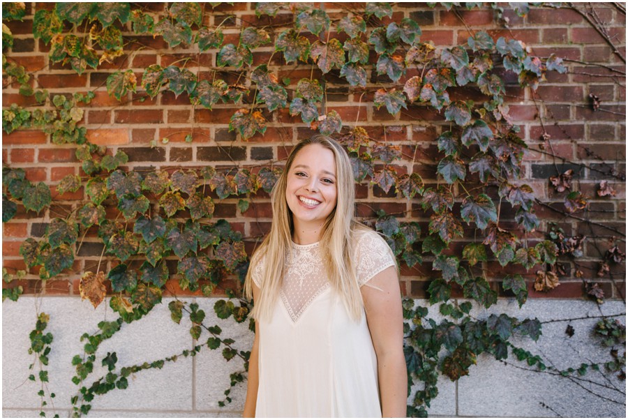 penn state graduate standing in front of vine wall