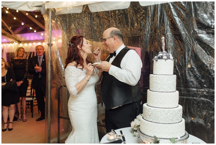 couple eating master bakers cake at loch aerie mansion wedding frazer pa
